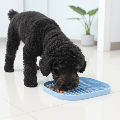 Dog eating from a blue slow feeder on a white floor.