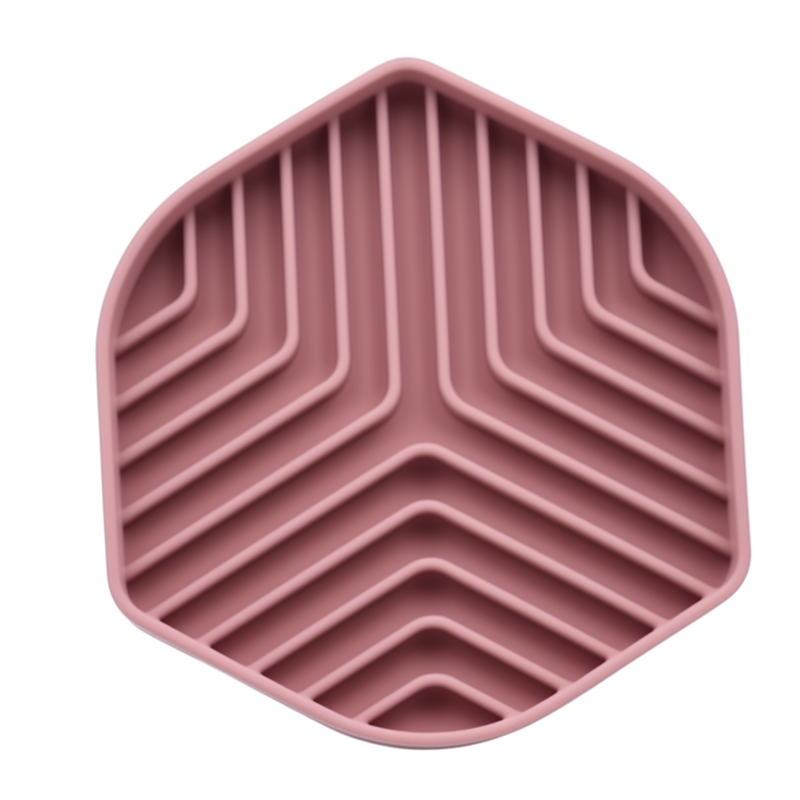 Pink silicone mat with zigzag pattern on a white background