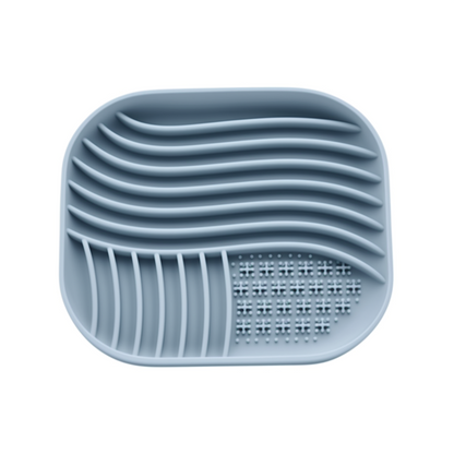 Blue silicone dish drainer with grid design on a white background