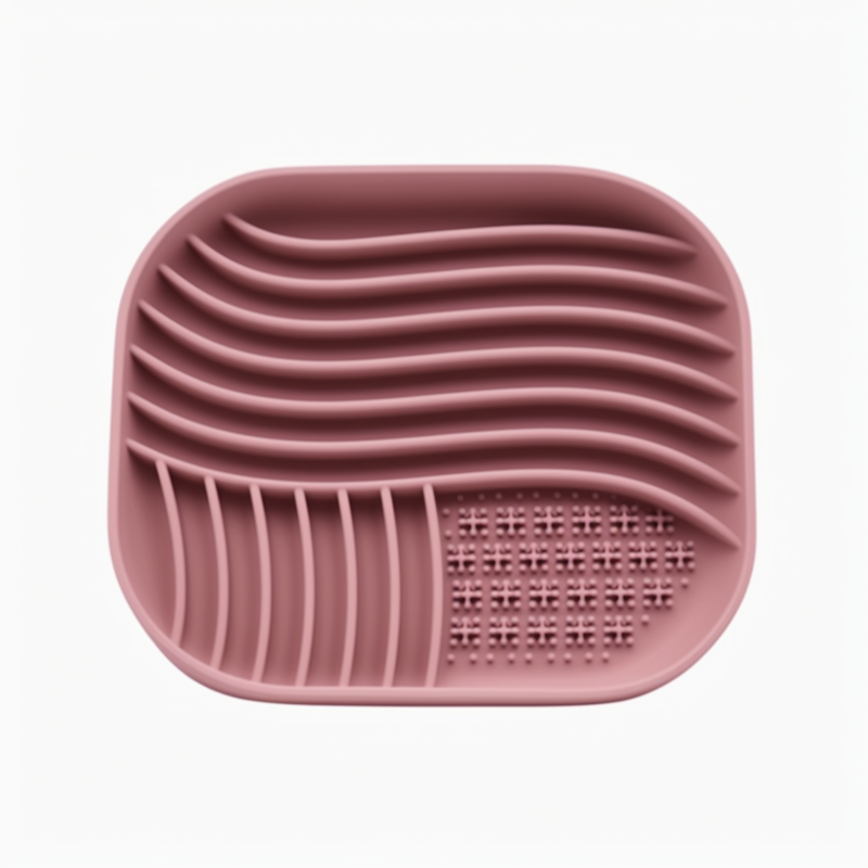 Pink silicone mat with textured surface on a white background