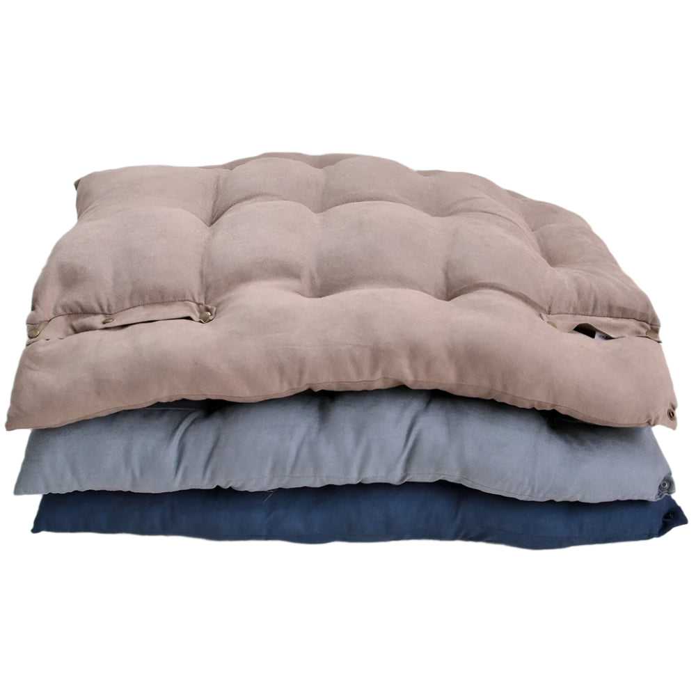 Stack of three folded blankets in brown, gray, and blue on a white floor.