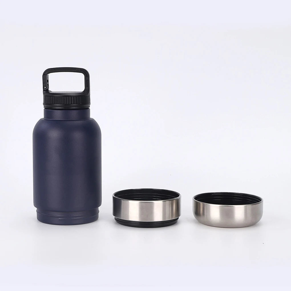 Navy blue insulated bottle with two stainless steel bowls on a white background