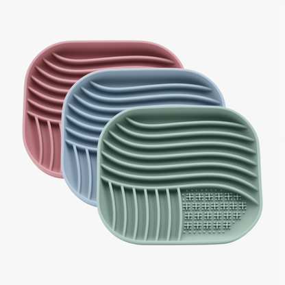 Three silicone mat with textured surface in pink, blue, and green on a white background