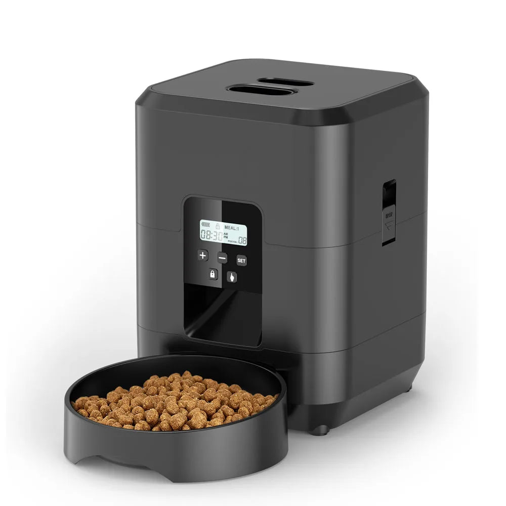 Black pet food dispenser with a bowl of kibble on a white background