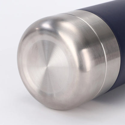 Close-up of a stainless steel thermos with a black exterior on a white background