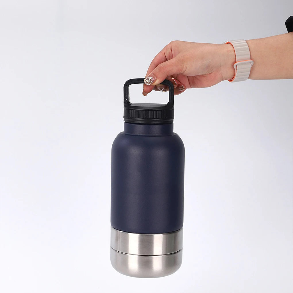 Hand holding a navy blue insulated bottle with a silver base on a white background